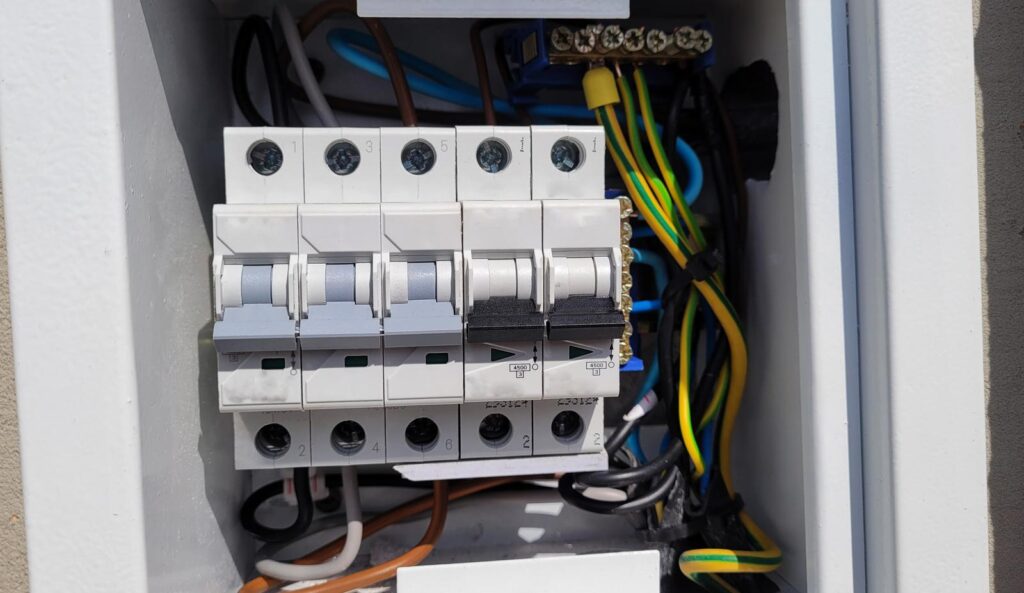 electricity distribution box with wires and circuit breakers (fuse box)