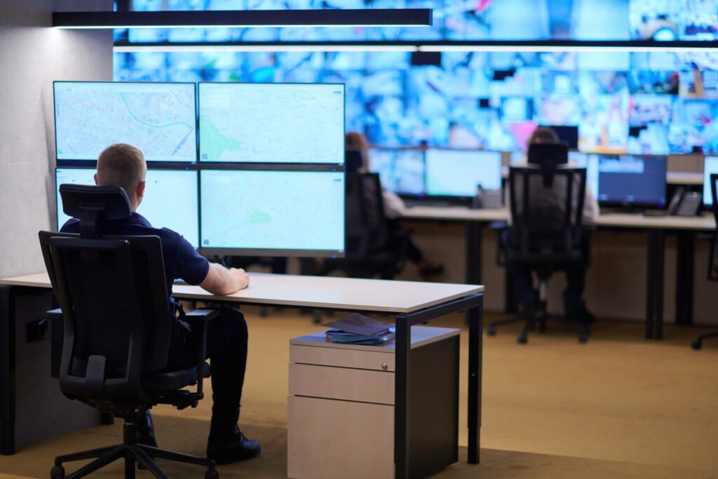 man watching screens in a security centre