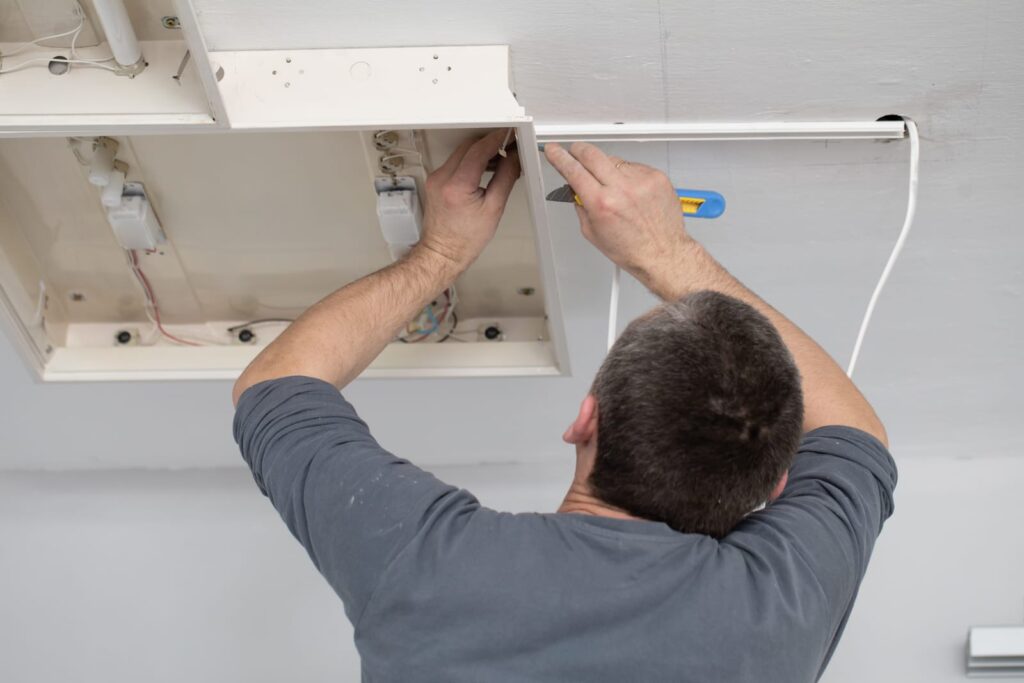 electrician checking old light installation